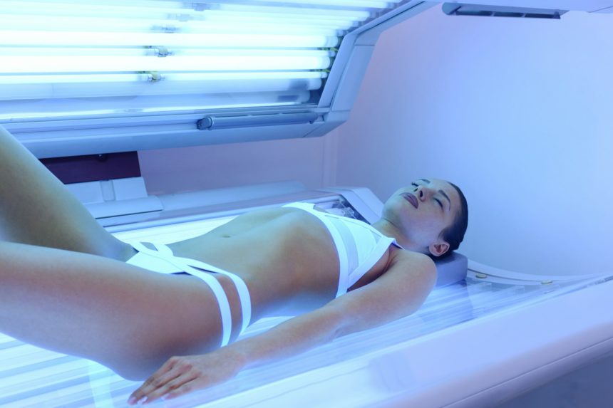 Attractive woman tanning at solarium