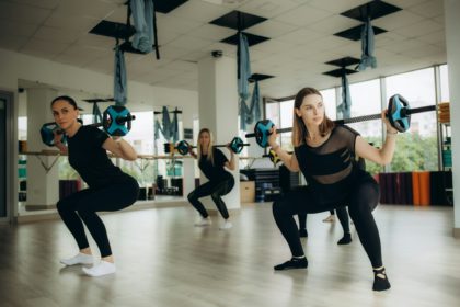 Cross training class of women doing deadlifts