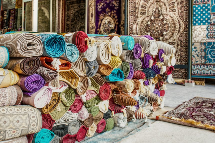 Heap of rolled up rugs in rug store